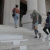 Three students walking into museum in Rome
