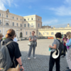 Group of adults standing in a Roman piazza